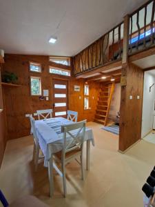 a dining room with a table and chairs and a loft at Refugio Purrunko in Pucón
