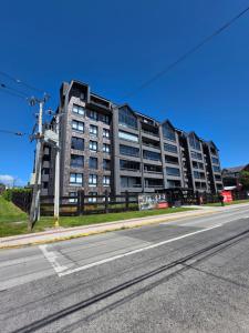 a large apartment building on the side of a street at Depto con Piscina Temperada 2D y 2B in Puerto Varas
