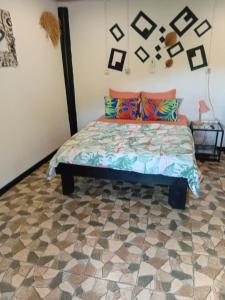 a bedroom with a bed with colorful pillows at Tereva home 2 in Bora Bora
