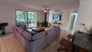 a living room with a couch and a table at Peaceful Country Home Between Brisbane & GC in Wolfdene