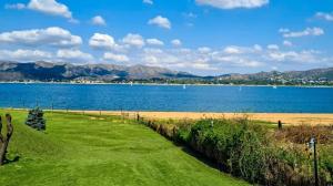 a view of a lake with mountains in the background at Cabañas Lago Azul in Villa Santa Cruz del Lago