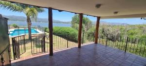 a balcony with a view of a swimming pool at Cabañas Lago Azul in Villa Santa Cruz del Lago