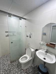 a bathroom with a shower and a toilet and a sink at Khách sạn Phương Danh in Phú Tài (1)