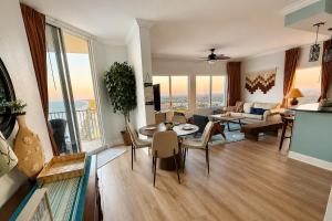 a living room with a couch and a table at Golden Hour Penthouse - TideWater Beach Resort 2700 in Panama City Beach