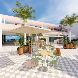 an outdoor patio with tables and chairs and umbrellas at Perla La Paz, Tapestry Collection By Hilton in La Paz