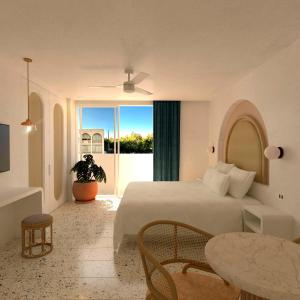 a bedroom with a bed and a table and a window at Perla La Paz, Tapestry Collection By Hilton in La Paz +28 photos