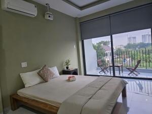 a bedroom with a large bed and a large window at Bống's Homesray and café in Ho Chi Minh City
