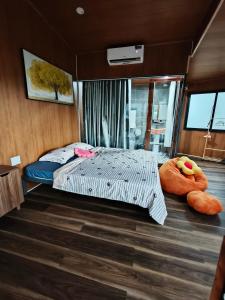 a bedroom with a bed and two large pillows at H Vy Homestay in Phương Phi