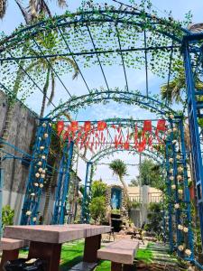 a large arch with a picnic table in a park at H Vy Homestay in Phương Phi
