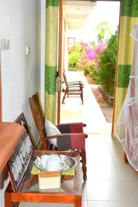 a room with a table and chairs and a doorway at New Hotel Bundala park in Tissamaharama
