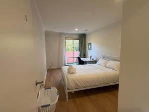 a bedroom with a bed and a window and a desk at Central Private Room - Stroll to ANU & City in Turner