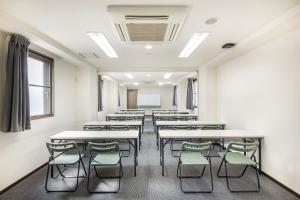 an empty room with desks and chairs in a classroom at Az Inn Fukui (Ace Inn Fukui) in Fukui
