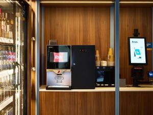 a desk with a ice machine on a shelf at Ibis Praha Wenceslas Square in Prague
