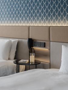 a hotel room with two beds and a table at T Hotel in Taichung