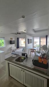 a room with a bed and a kitchen with a sink at ClubBoracay Apartelle in Boracay