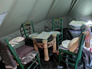 a room with chairs and a table in a tent at Goldenrod Gap in Wellington