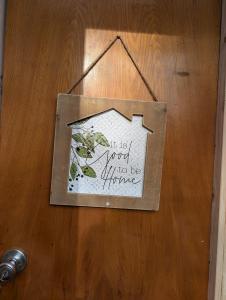 a sign hanging on a wooden door with the words it is not supposed to be at Goldenrod Gap in Wellington