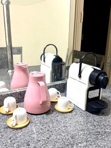 a counter with a toaster and a tea pot and hats at Apto Aquarius - Piscinas Aquecidas, Hidro e Lazer Total - até 5 Pessoas in Caldas Novas