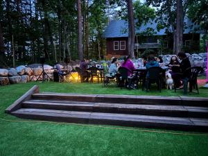 a group of people sitting at tables in a park at snowhere ski lodge in Hakuba