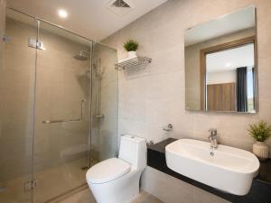 a bathroom with a toilet and a sink and a shower at Jess Apt in Tuy Hoa +19 photos