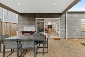 a dining room table and chairs in a backyard at Point Retreat in Point Lonsdale +7 photos