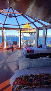 a room with two beds and a view of the ocean at Titicaca House Mariela in Puno