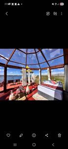 a photograph of a bedroom with a view of the ocean at Titicaca House Mariela in Puno