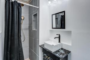 a bathroom with a sink and a shower at Centralized Modern Home in Johnson City in Johnson City +16 photos