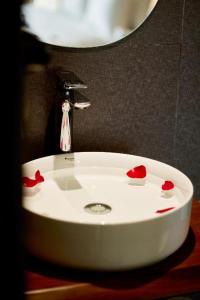 a white bathroom sink with red hearts on it at Smile House - With In-unit Laundry & Kitchen in Sapa +46 photos