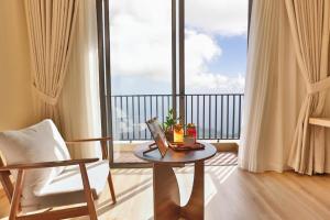a room with a table and a balcony with a view at Smile House - With In-unit Laundry & Kitchen in Sapa