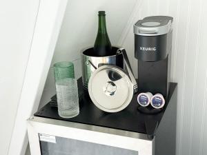a counter with a bottle of wine and a blender at Seneca Gorge Glamping in Hector