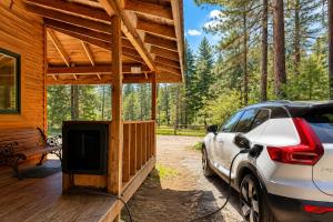 a car parked in front of a cabin with a tv at Pine Acres by NW Comfy Cabins in Leavenworth
