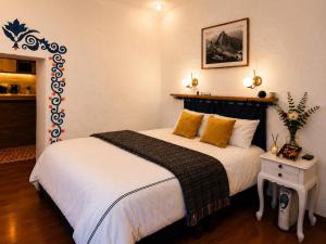 a bedroom with a large bed with yellow pillows at Apartamento de confort en el Centro Histórico de Cusco in Cusco