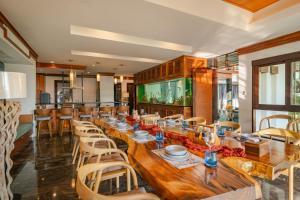 a dining room with a long wooden table and chairs at Kiri Anda Villa Phuket in Rawai Beach +262 photos