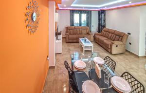a dining room with a table and chairs and a couch at Taurus 13 in Jun