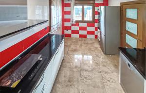 a kitchen with a stove and a refrigerator at Taurus 13 in Jun