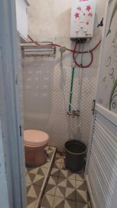 a small bathroom with a toilet and a shower at UnitA 5BR Kangen Homestay Jambon Yogyakarta in Cebongan +36 photos