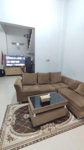 a living room with a couch and a coffee table at UnitA 5BR Kangen Homestay Jambon Yogyakarta in Cebongan