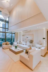 a living room with white furniture and a chandelier at ChiHome Metropole The Opera Residence Luxury in Ho Chi Minh City +287 photos