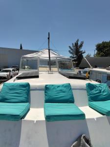 a boat with two blue seats on the back at party like a local in Key West