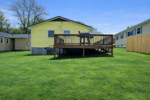 a large deck in a yard next to a house at Centralized Modern Home in Johnson City in Johnson City