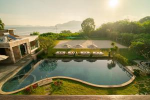 an overhead view of a swimming pool at a resort at Kiri Anda Villa Phuket in Rawai Beach