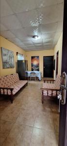 a living room with two couches and a bed at Casa de Nivia in Acequias Abajo
