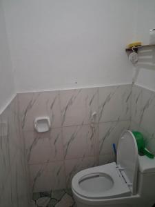 a bathroom with a white toilet in a room at Bebot's Breakfast #01 in Daanbantayan