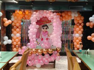 a wall of balloons with a picture of a girl in a mirror at Hotel Sukhdham in Allahābād