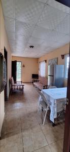 a living room with a table and a refrigerator at Casa de Nivia in Acequias Abajo +9 photos