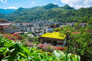 a view of a city with flowers and mountains at Sapa Village Hotel in Sapa