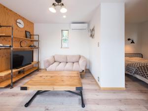 a living room with a couch and a coffee table at Mobile Home 8 in Hokuto