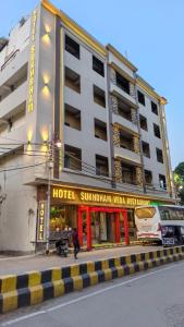 a hotel on a street in front of a building at Hotel Sukhdham in Allahābād
