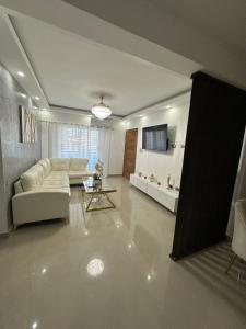 a living room with a couch and a table at Elegant and comfortable and exclusive first level in Santo Domingo